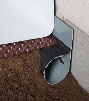 Closeup of a crawl space drainage system installed in Vandalia