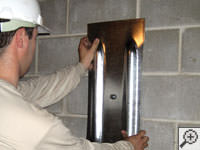 Mounting a foundation wall plate for an earth anchor installation in Florence, KY.