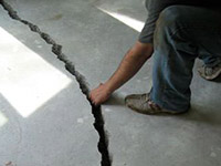 a severely damaged cracked concrete slab floor in Hamilton