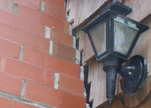 A tilting chimney in Burlington, KY showing serious foundation damage.