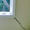 A long, diagonal crack that begins at a window corner of a Sidney home