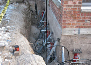 Foundation push piers installed around a house with a foundation settlement issues in Vandalia