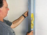 straightening the i-beam system and wall brace in Guilford, IN.