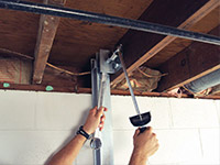 Straightening a foundation wall with the PowerBrace™ i-beam system in a West Chester home.