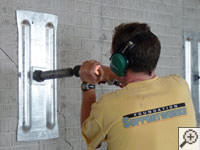 Mounting the steel wall plate for foundation wall repair and straightening in Troy.