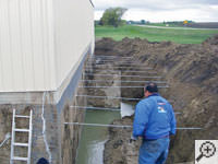 Drilling the hole in the foundation wall for street creep repairs in Miamisburg