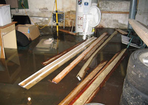 A severely flooding basement in Mason, with lumber and personal items floating in a foot of water