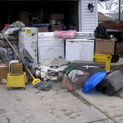 Soaked, wet personal items sitting in a driveway, including a washer and dryer in Covington, KY.