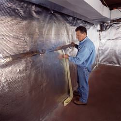 Installation of a radiant heat and vapor barrier on a basement wall in Lebanon