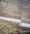 Our baseboard drain system installed on a corner in a Mason basement.