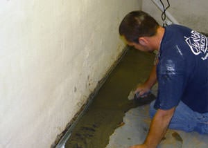 Restoring a concrete slab floor with fresh concrete after jackhammering it and installing a drain system in Erlanger, KY.