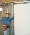 Installing wall panels on top of our basement wall insulation in Covington, KY