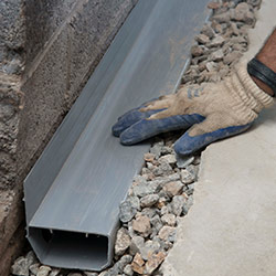 installing a drain tile system in a Piqua home